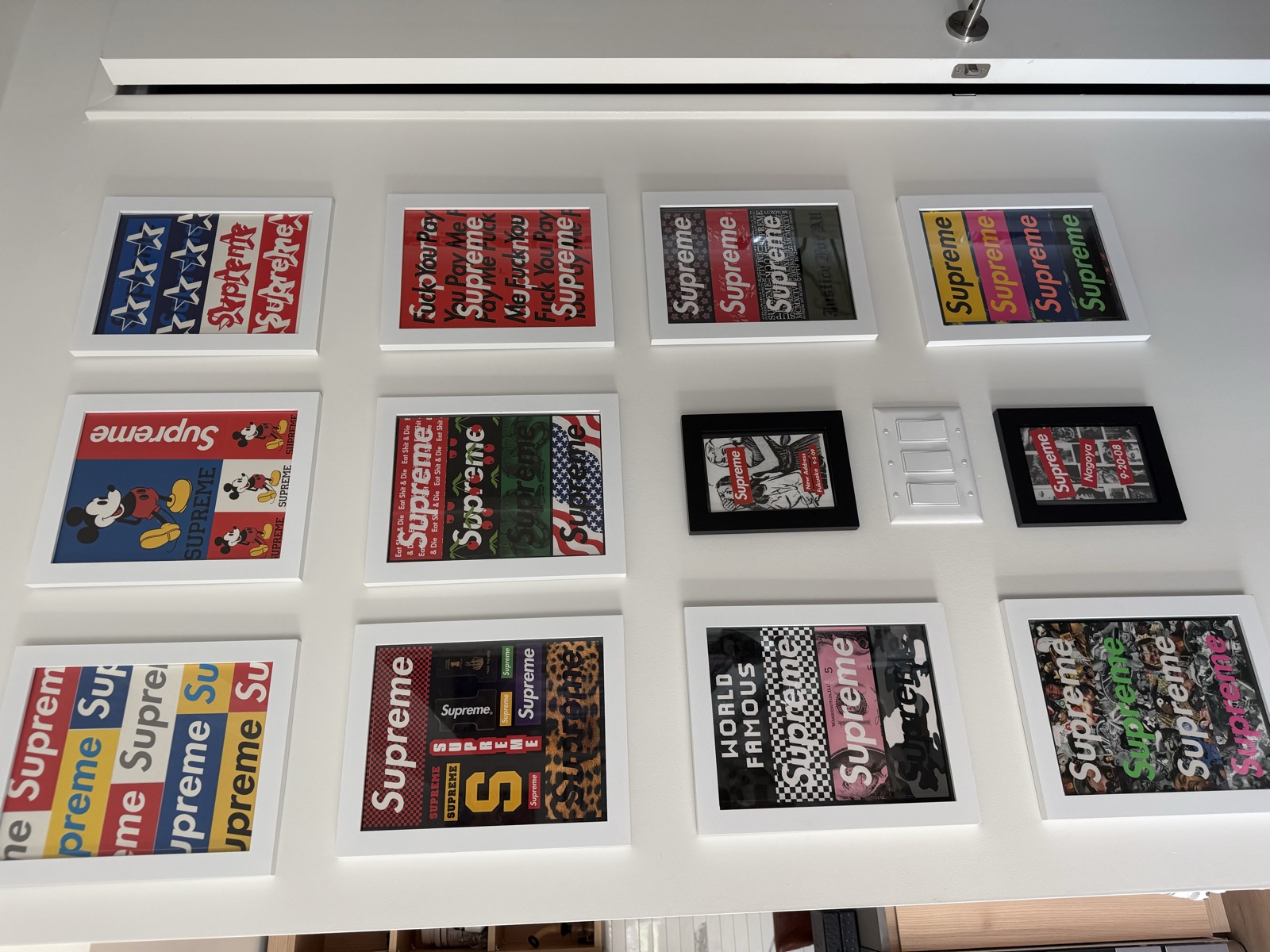 A wall displaying our framed collector artwork
